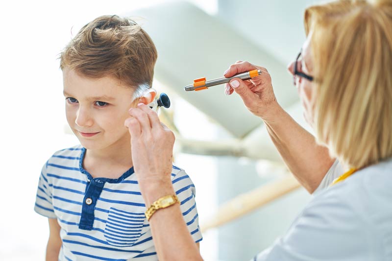 Child getting earwax removed
