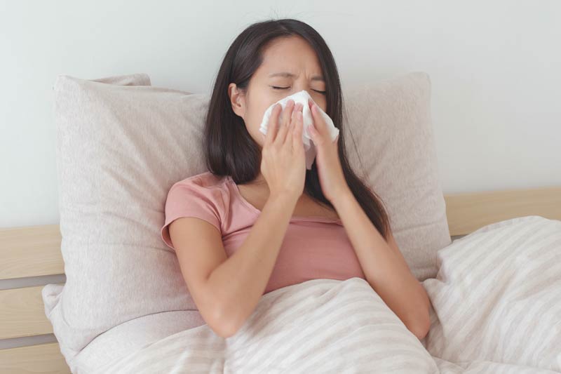 woman suffering from nosebleed