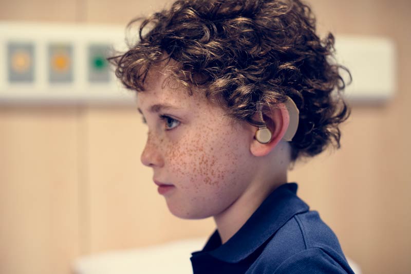 Young boy with hearing aid