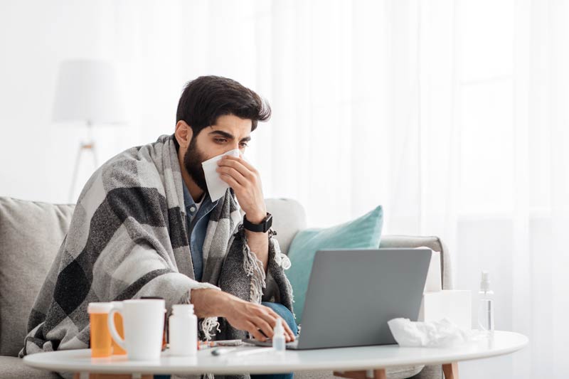 Arab young man blowing nose with postnasal drip