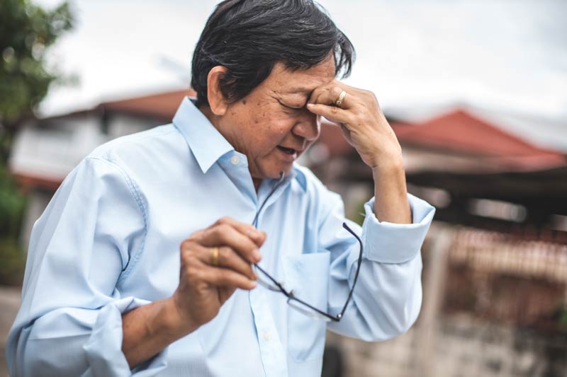 Elder man holding nose with sinus pressure