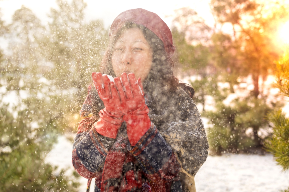 Woman enjoying the outdoors with snow after recovering from a cold