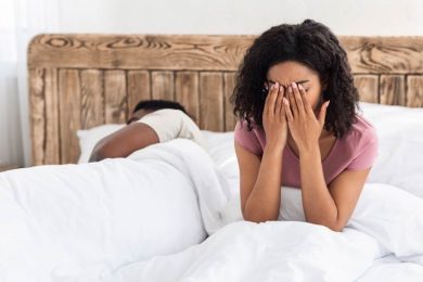 African American woman in bed with sleep issues