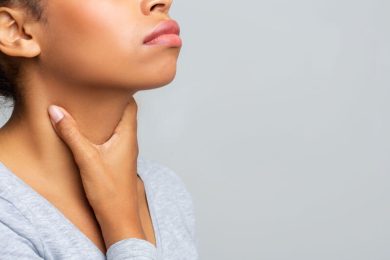 black woman touching her neck having pain in throat