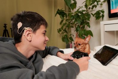 deaf boy with cochlear implant playing computer game