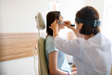 female ent doctor and patient in office ear exam